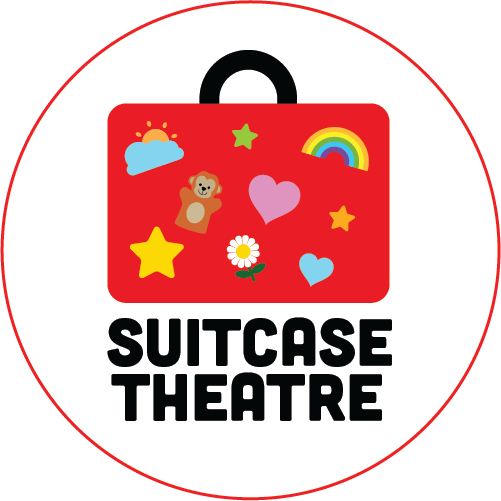Red suitcase with black handle covered in stylized stickers of rainbows and hearts. Suitcase Theatre in black bold type below
